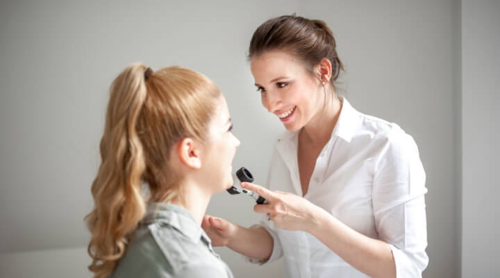 Dermatologist inspecting patient's face