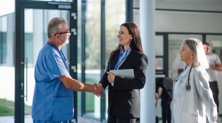 healthcare professionals talking to business woman
